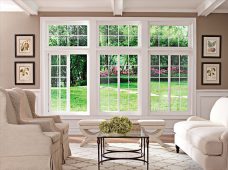 New energy-efficient replacement windows installed in a Toledo, Ohio home, featuring large white-framed windows that bring in natural light and provide a clear view of the landscaped backyard.